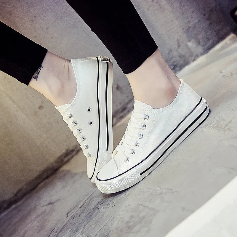 Women's solid colour canvas slip-on sneaker in black on a white background.