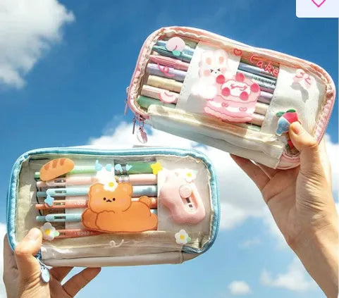 Transparent heart-shaped pencil case with Korean style design in pink rabbit theme showing pens inside