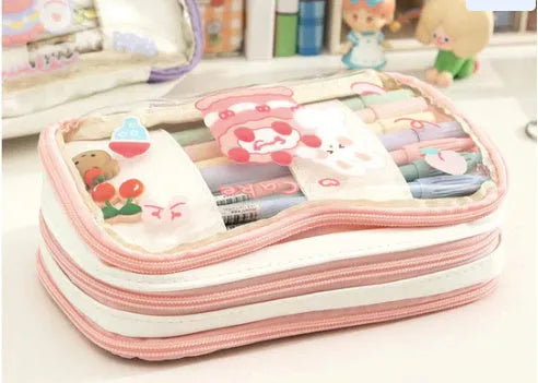 Transparent heart-shaped pencil case with Korean style design in pink rabbit theme showing pens inside