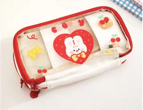 Transparent heart-shaped pencil case with Korean style design in pink rabbit theme showing pens inside