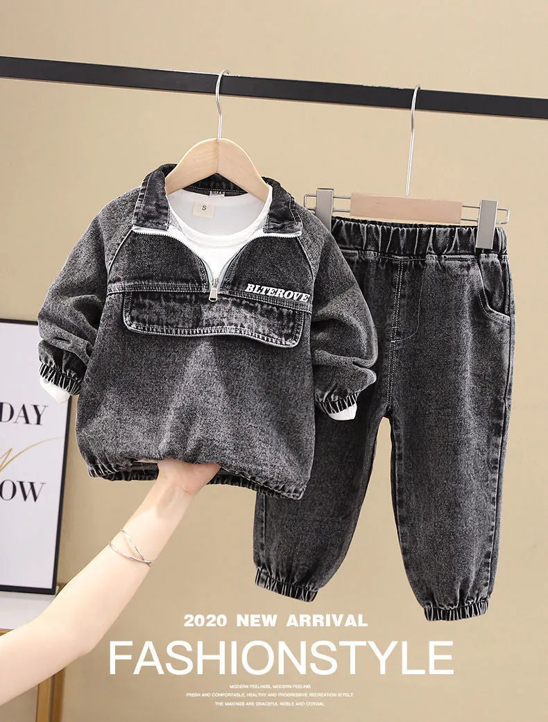 Boys' black denim two-piece suit with long sleeves, shown on a hanger.
