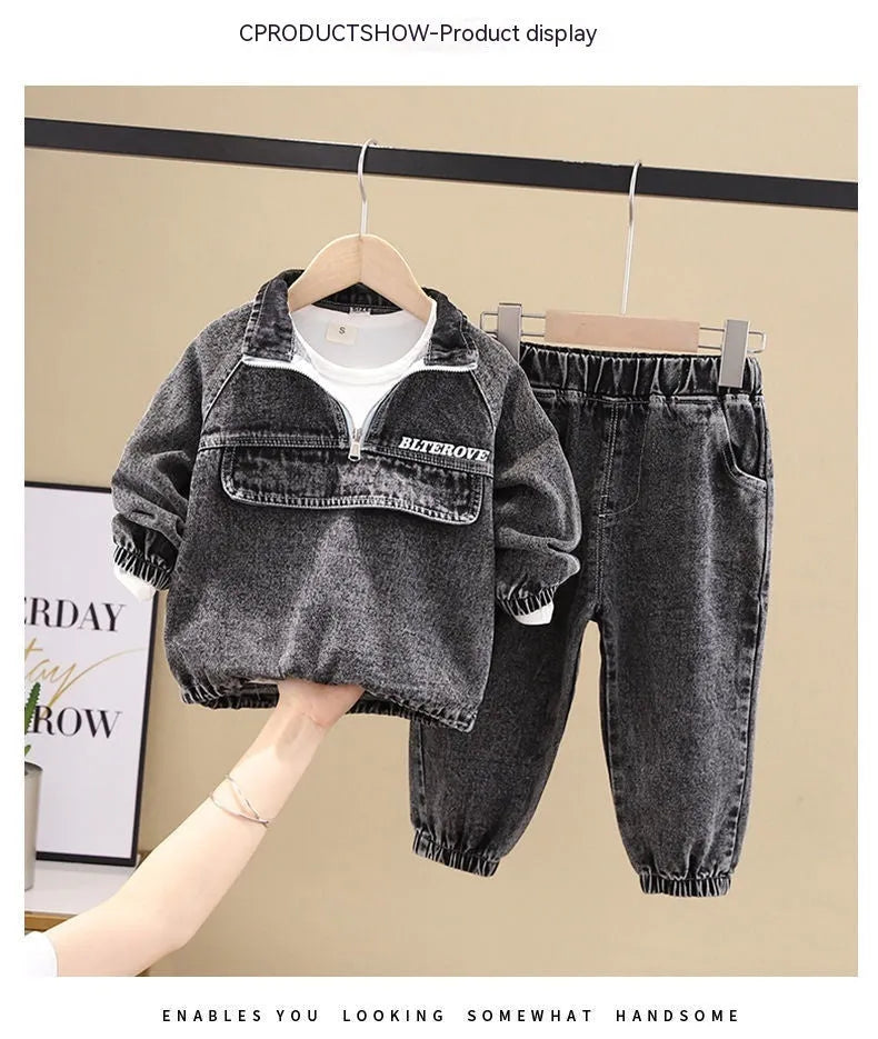 Boys' black denim two-piece suit with long sleeves, shown on a hanger.