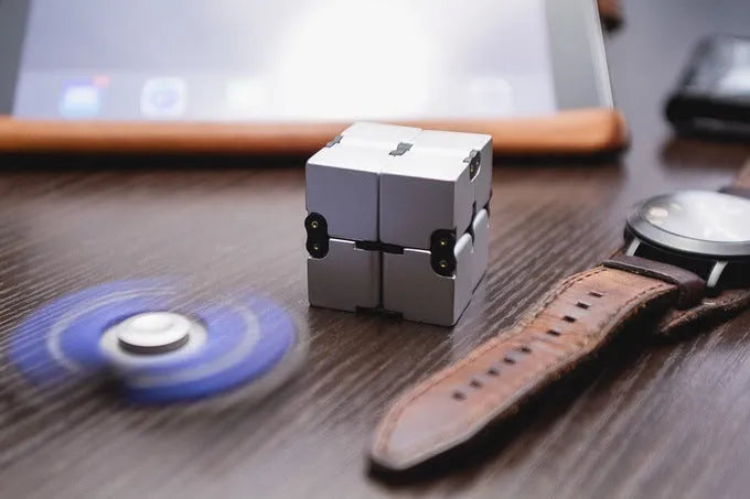 Zinc alloy infinity cube fidget toy showing black metallic finish and rotatable cube design