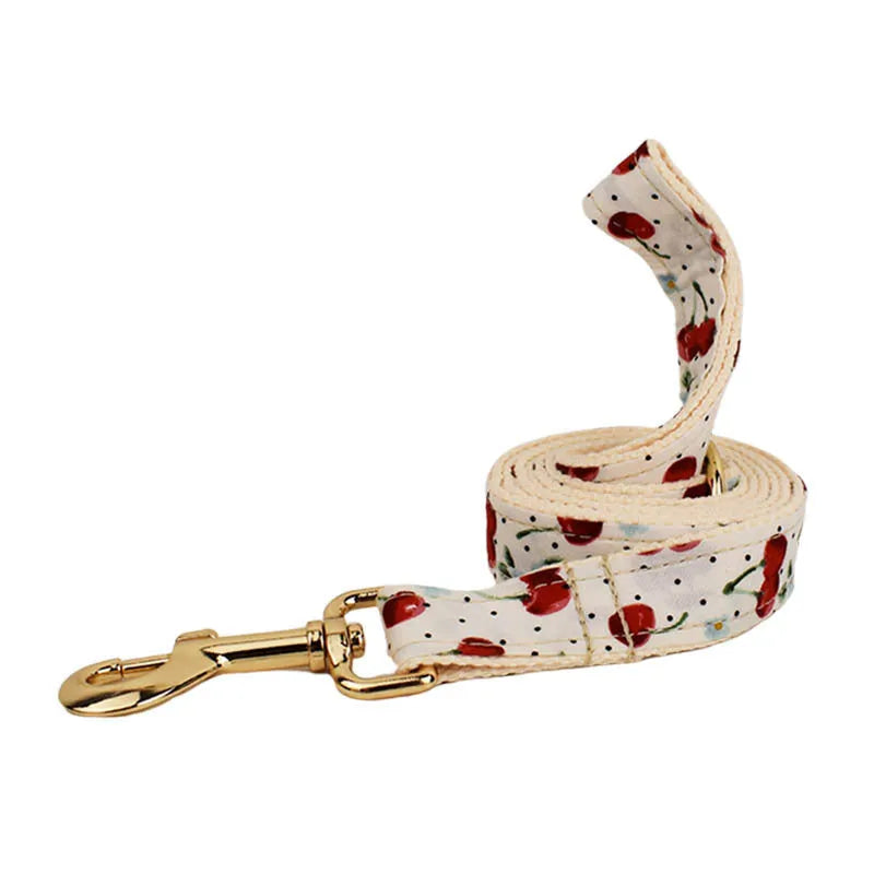Red cherry printed dog collar set with leash, vest, poop bag, bow and light gold buckle