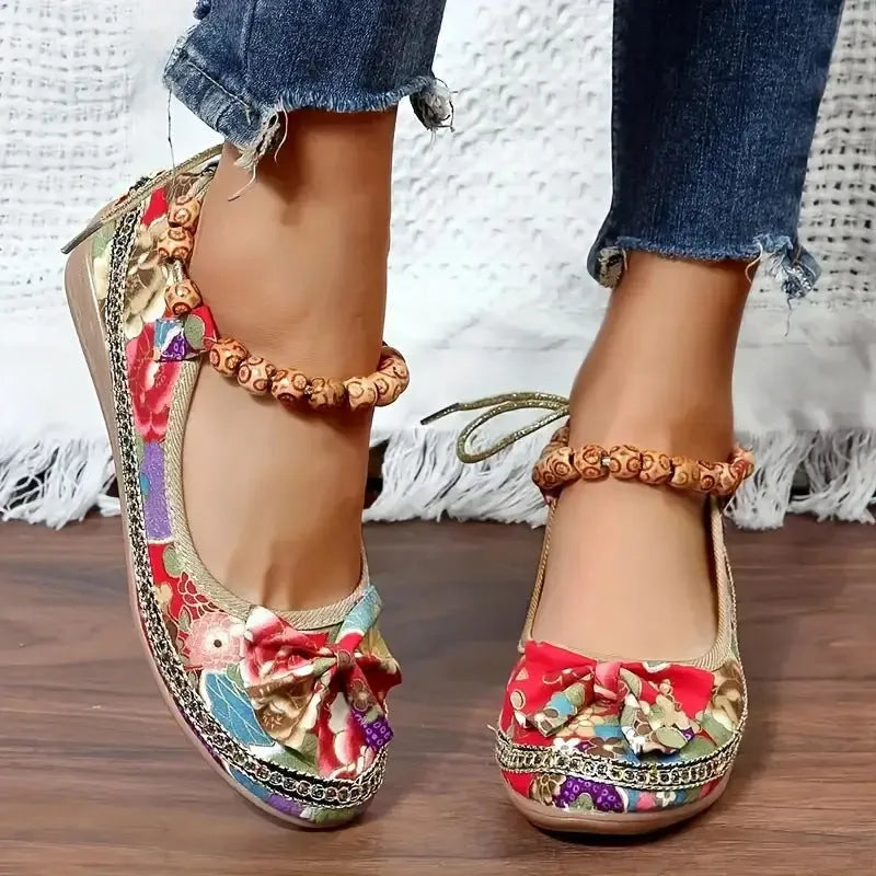Women's black plus-size ethnic platform sandals with cloth upper and elastic band strap.