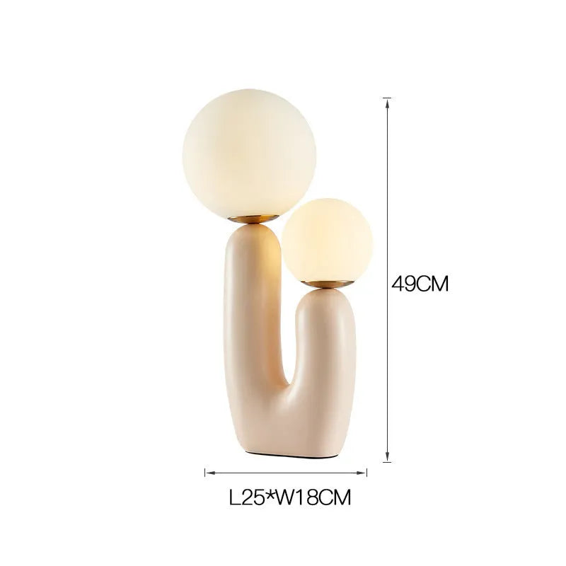 Pink double-head resin table lamp with glass shades on a bedside table, 49cm height
