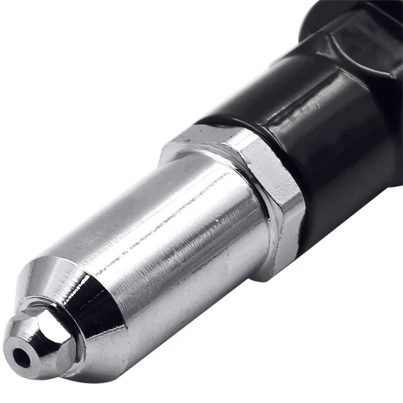 Black metal electric drill rivet gun adaptor with handle, wrench, and four rivet heads on a workbench.