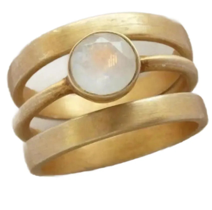 Gold geometric titanium steel ring with a small white chalcedony stone set in a hollow design.