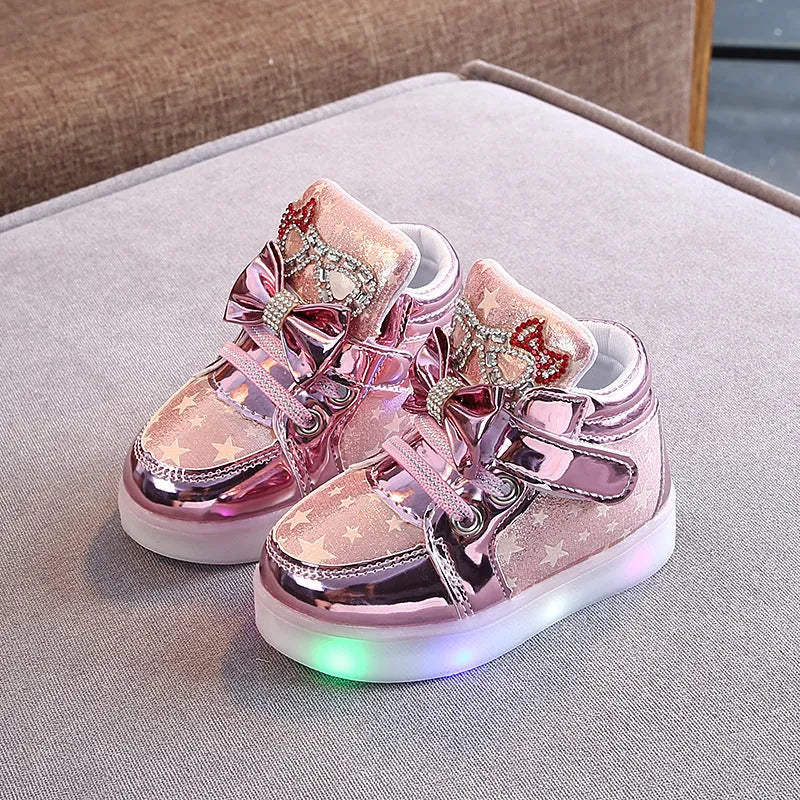 Golden children's LED sneakers with a light-up magic button on the heel