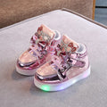 Golden children's LED sneakers with a light-up magic button on the heel