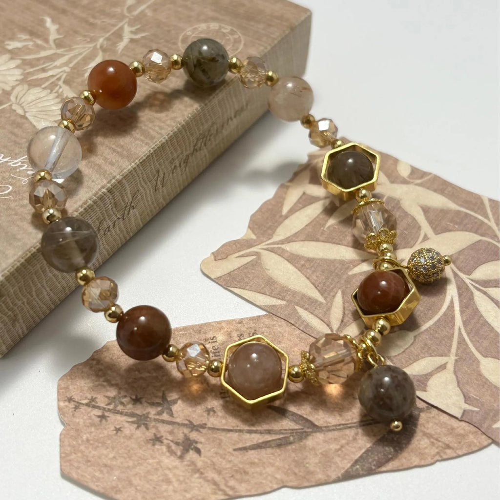 Gold crystal bracelet with 8mm beads showing hand-woven construction and traditional auspicious symbols