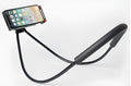 White universal smartphone neck holder with 360-degree rotating clamp on a table.