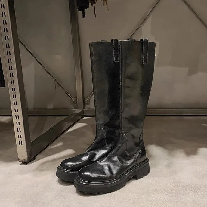 Women's black knee high chunky heel boots with round toe and back zipper.