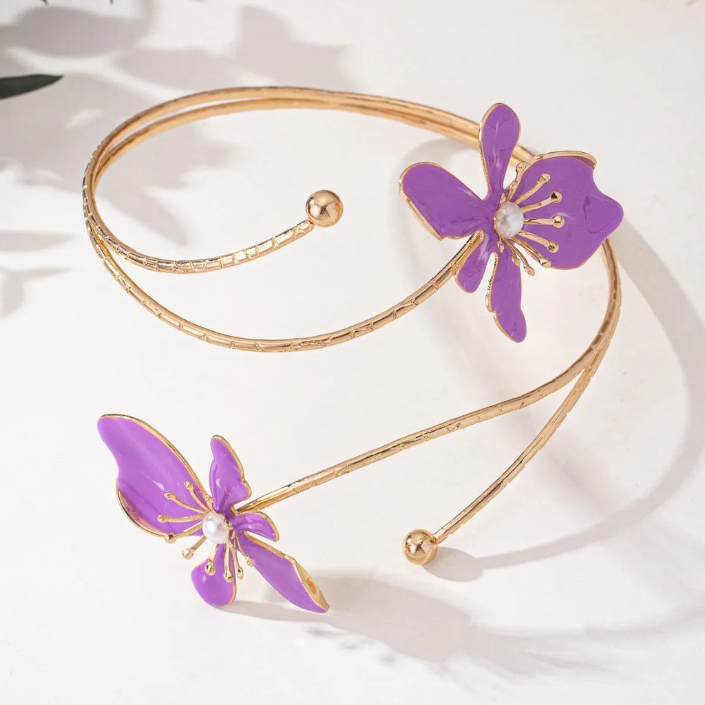 Close-up of a pink hollow patterned alloy armband for women's fashion.