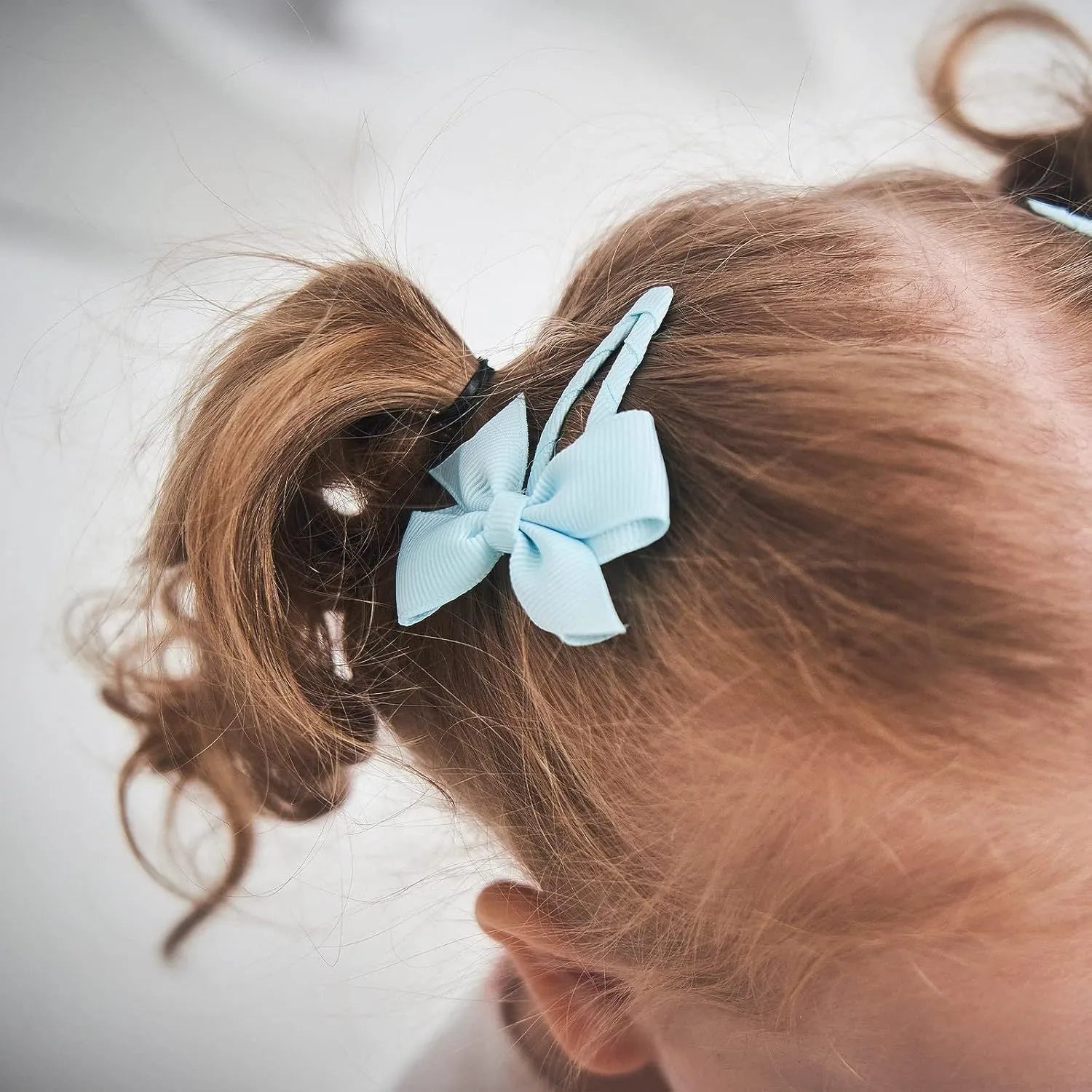 40-piece set of multicoloured grosgrain ribbon baby hair bows with fully wrapped snap clips.