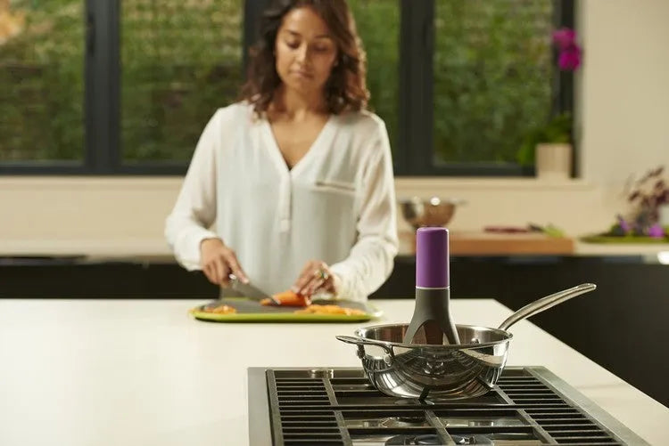 Green or grey Uutensil Stirr automatic pot mixer device for hands-free stirring of sauces and soups.