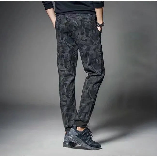 Men's black jogging pants made from acetate and modal fabric, side view on model