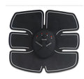 Black EMS muscle stimulator device with electrode pads for abdominal toning and slimming