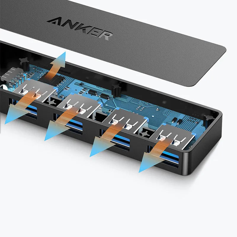 Black Anker 4-port USB 3.0 hub with short attached cable on a desk.