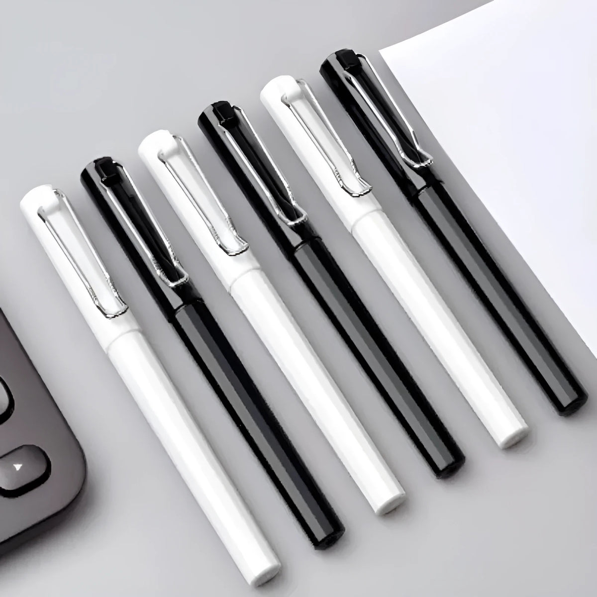 Three black decompression elastic pens with 0.7mm bullet tips and cap closure on a light background