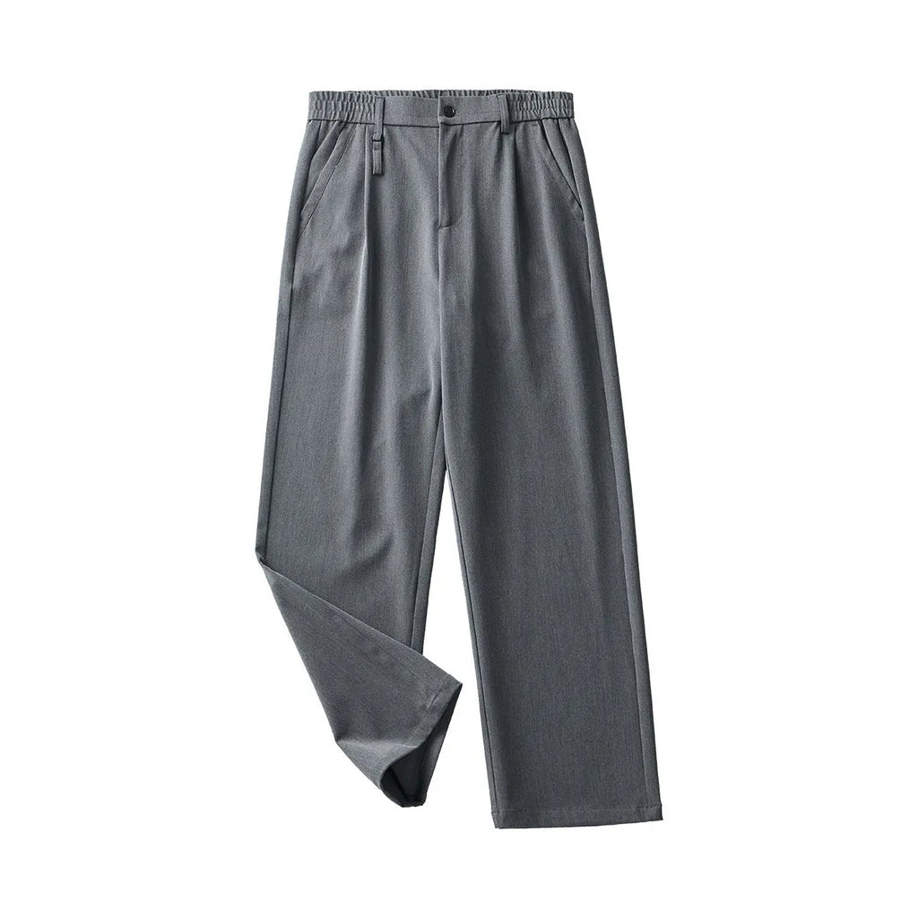 Man wearing loose straight-leg black business casual trousers made from polyester blend fabric.