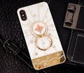 Rose gold and white gold iPhone ring stands with a diamond accent on a phone back.