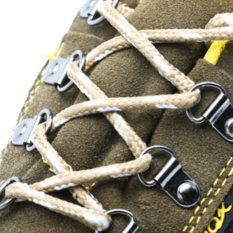 Bronze coloured low-cut cow suede leather safety shoes with a steel toe cap on a work surface.