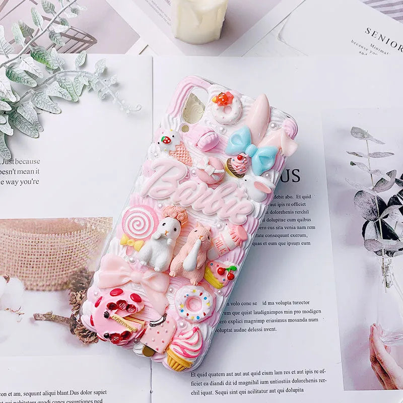 Pink and green 3D silicone phone cases with raised cartoon rabbit designs for iPhone.