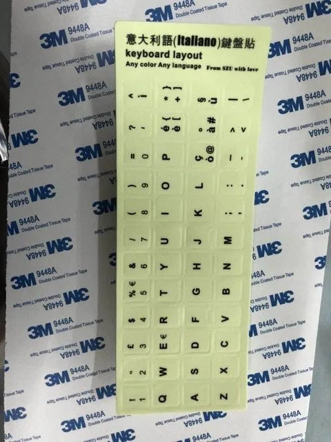 Yellow glowing keyboard stickers showing Arabic, Thai, Hebrew, French, Italian and German characters on PVC sheet