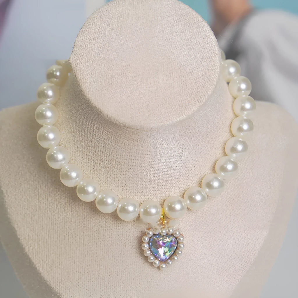 Cat collar with plastic heart charm in blue, shown alongside pink, green, purple, transparent and sapphire blue colour options