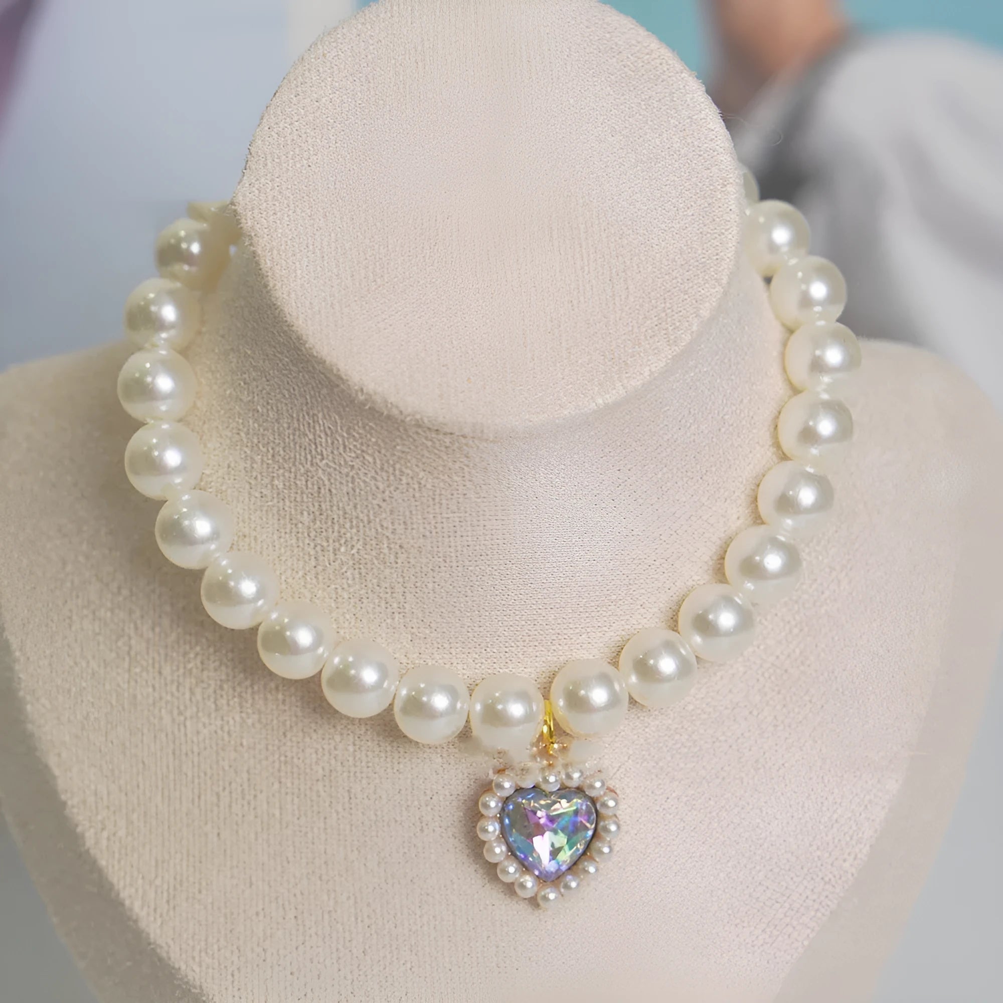 Cat collar with plastic heart charm in blue, shown alongside pink, green, purple, transparent and sapphire blue colour options
