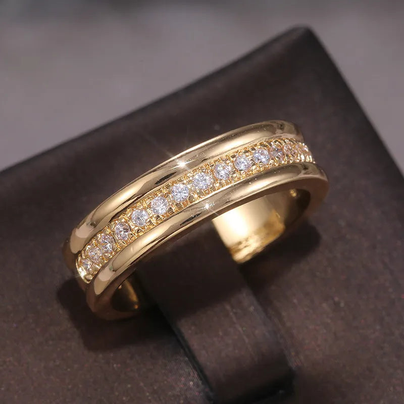 Gold plated geometric rhinestone ring with inlaid stone on white background, size options
