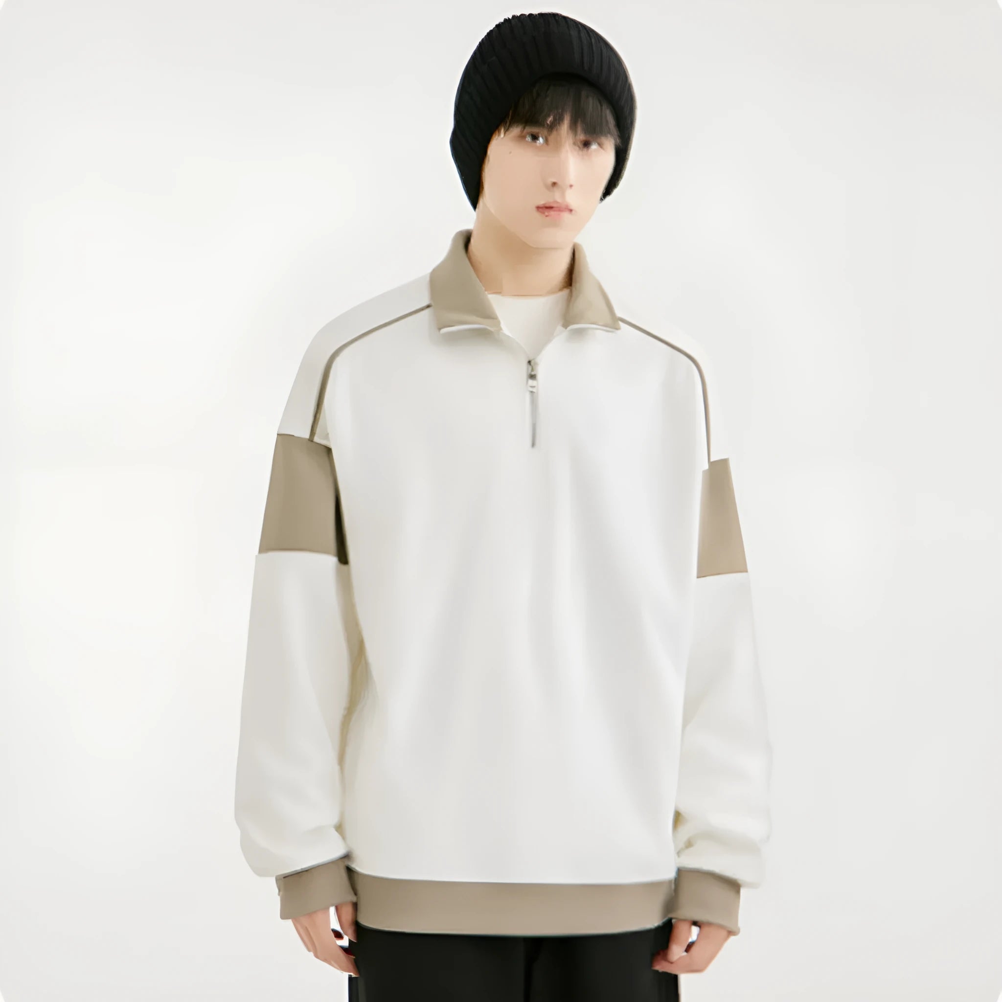 Man wearing a beige hooded corduroy sweater with drop shoulders and loose lapels.