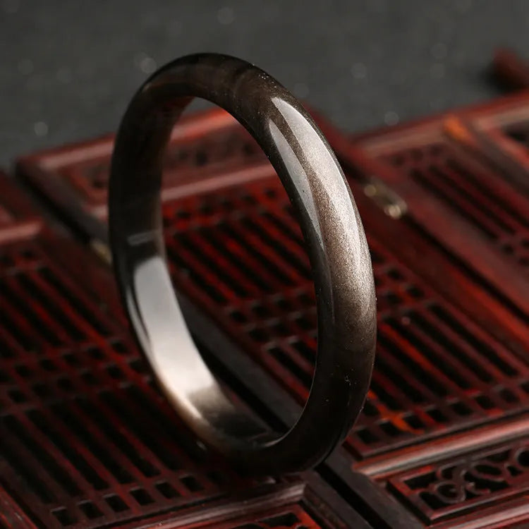Geometric ethnic bracelet with a central cat's eye stone, made from crystal and alloy metal.