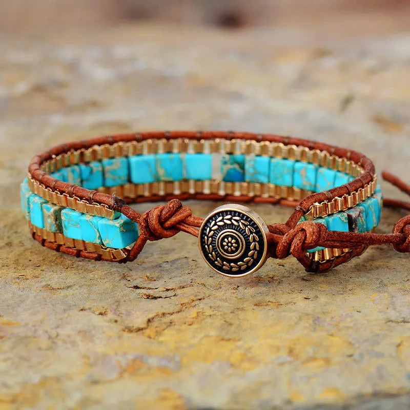 Blue hand-woven leather bracelet with geometric pattern on neutral background
