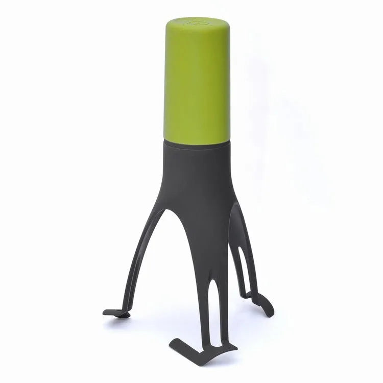Green or grey Uutensil Stirr automatic pot mixer device for hands-free stirring of sauces and soups.
