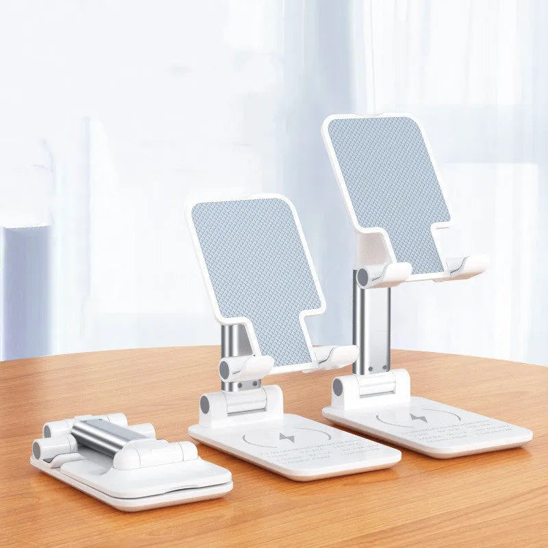 Cool black desktop phone stand with integrated Qi wireless charging pad on a wooden desk.