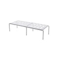 White telescopic kitchen storage rack with adjustable height on a countertop
