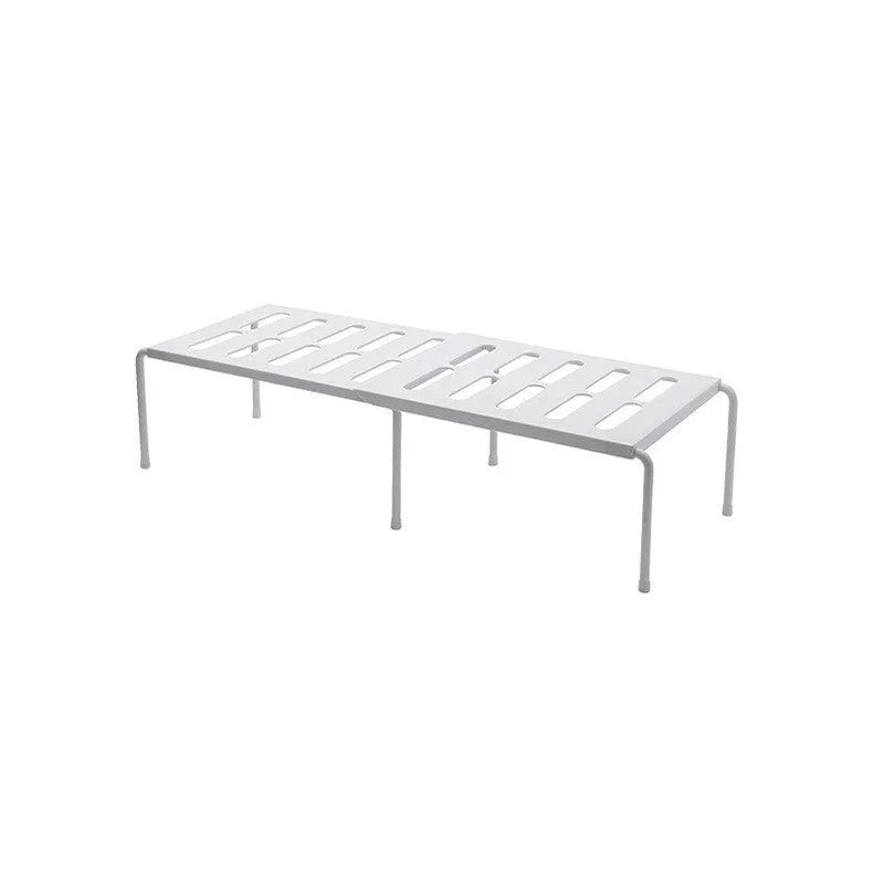 White telescopic kitchen storage rack with adjustable height on a countertop