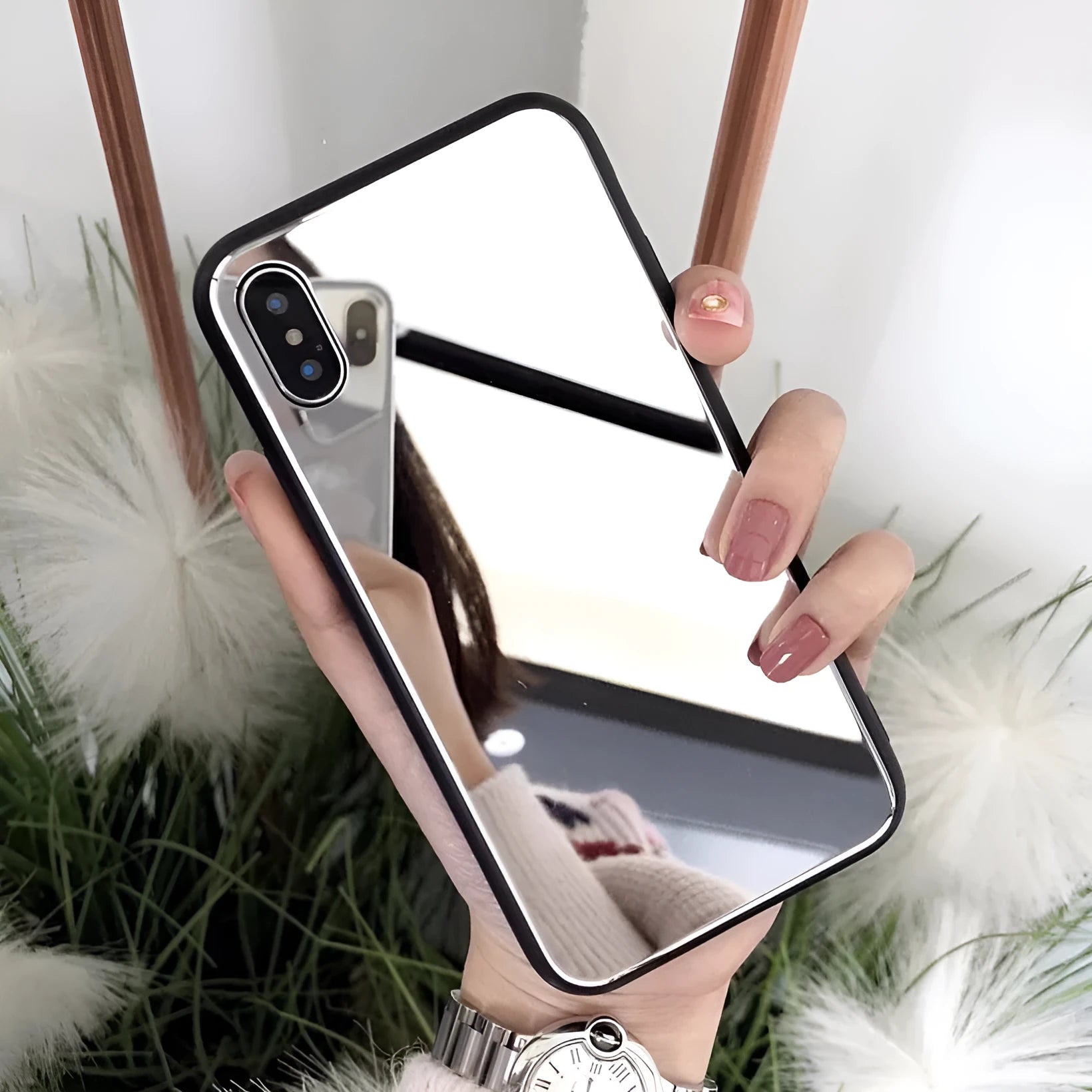 Black iPhone mirror phone case showing reflective surface on back, compatible with iPhone X and Plus models.