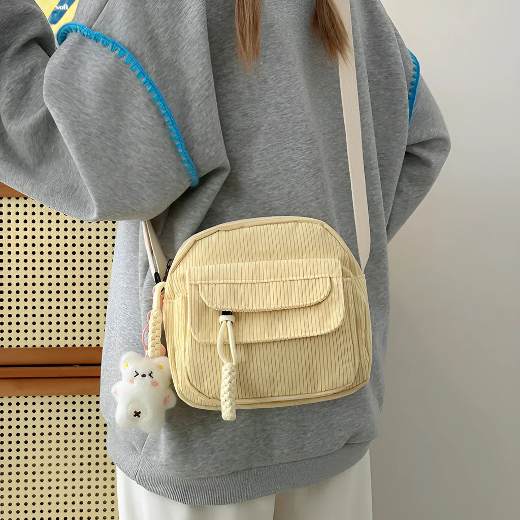 Corduroy crossbody shoulder bag in black with ribbon pendant, horizontal square shape