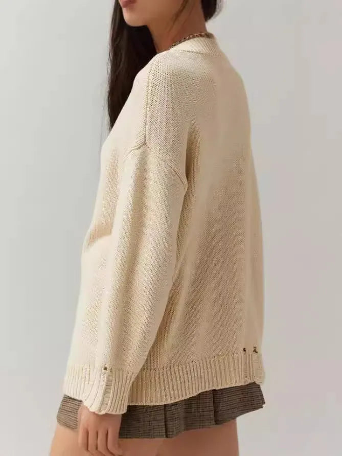 Women's loose-fitting milky white acrylic sweater with Jacquard knit texture and round neck.