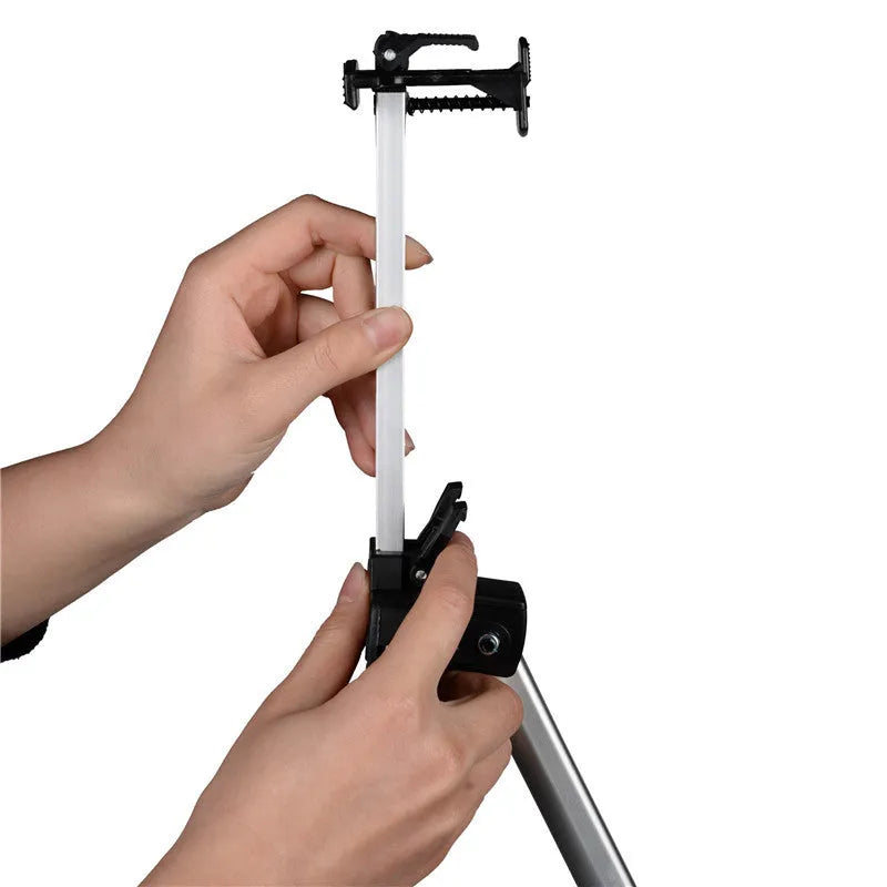 Silver aluminium alloy adjustable easel with metal tray in collapsed position on a tabletop