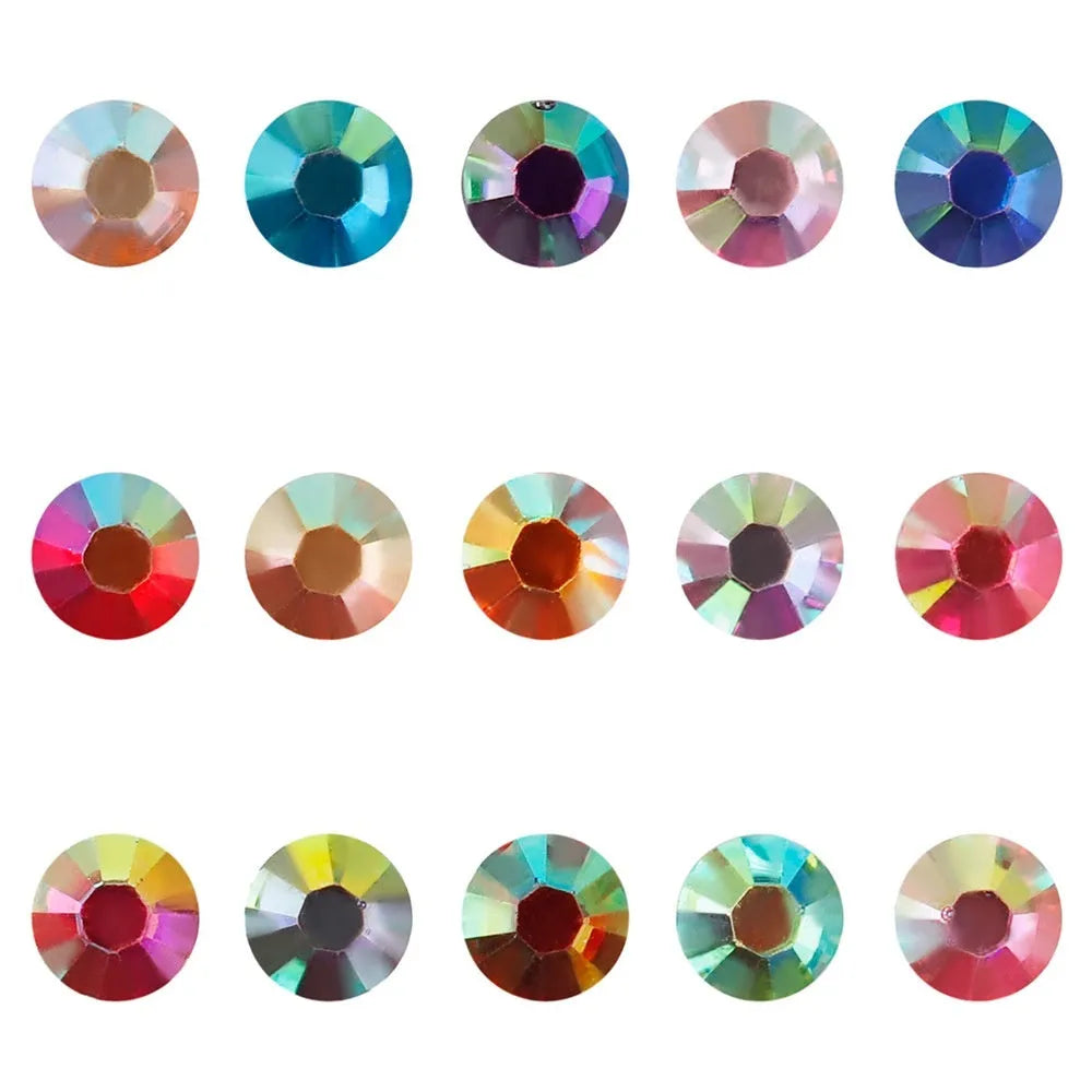 Assortment of multicoloured flat back resin rhinestones in various sizes for nail art and craft projects.