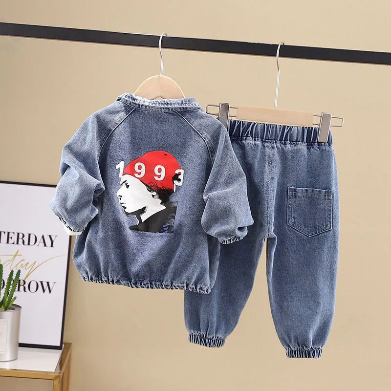 Boys' black denim two-piece suit with long sleeves, shown on a hanger.