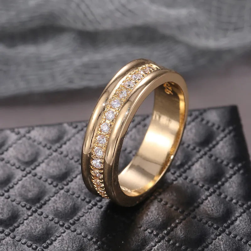 Gold plated geometric rhinestone ring with inlaid stone on white background, size options