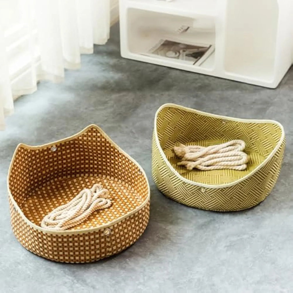 Green woven rattan cat hammock with metal hooks, hanging on a white shelf with a cat resting.