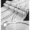 Close-up of light grey 3D curve stripe wallpaper with a thick deerskin velvet texture.