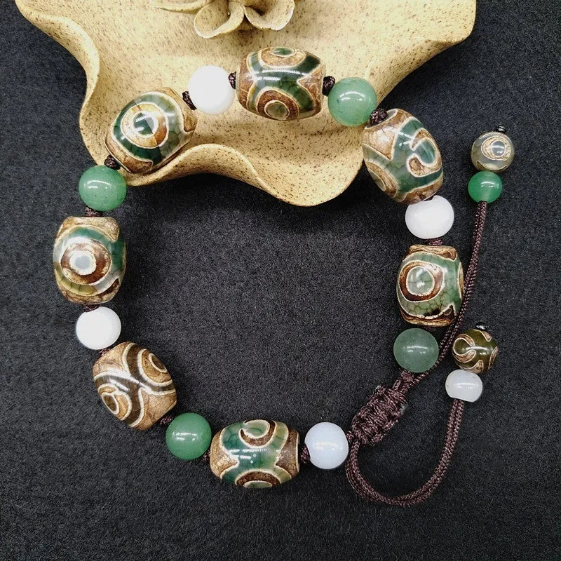 Green agate ethnic bracelet with hand-woven beads showing geometric patterns and three-eye design details