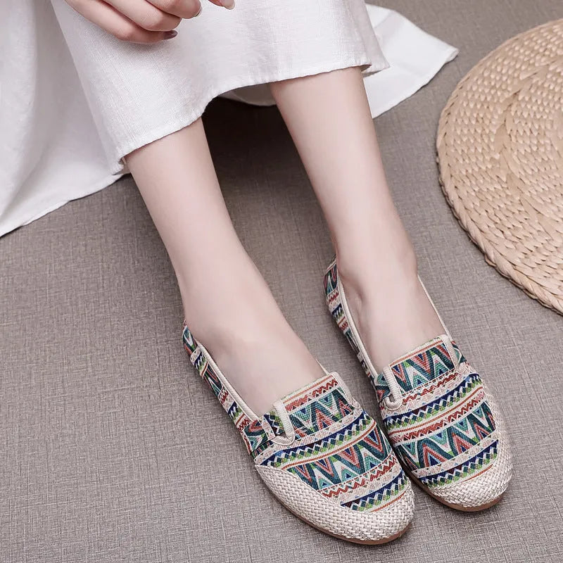 Women's ethnic style flat heel cloth shoes with colour stitching and shallow mouth design.
